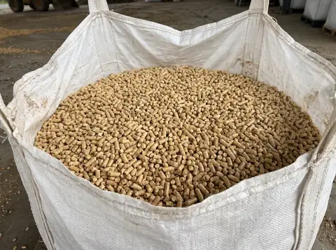 An open jumbo bag filled with wood pellets